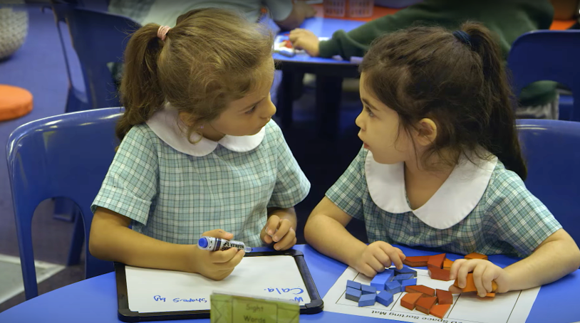 Two primary school students studying mathematics 